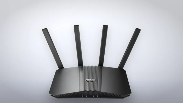 Front of the black ASUS RT-BE82U router with its four external antennas raised, on a light gray studio background